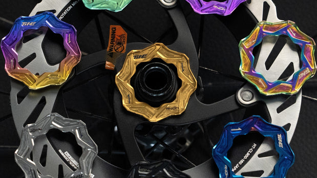 Multiple TiNE disc centerlock caps in colorful anodized designs