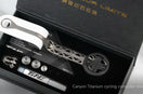 Canyon CP0018 titanium computer mount with geometric cutout design, white rubber grip, circular phone clamp, and mounting hardware displayed in black TiNE TECH packaging