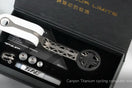 Canyon CP0018 titanium computer mount with geometric cutout design, white rubber grip, circular phone clamp, and mounting hardware displayed in black TiNE TECH packaging