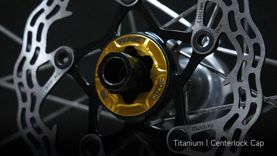 TiNE titanium centerlock cap installed on bicycle hub