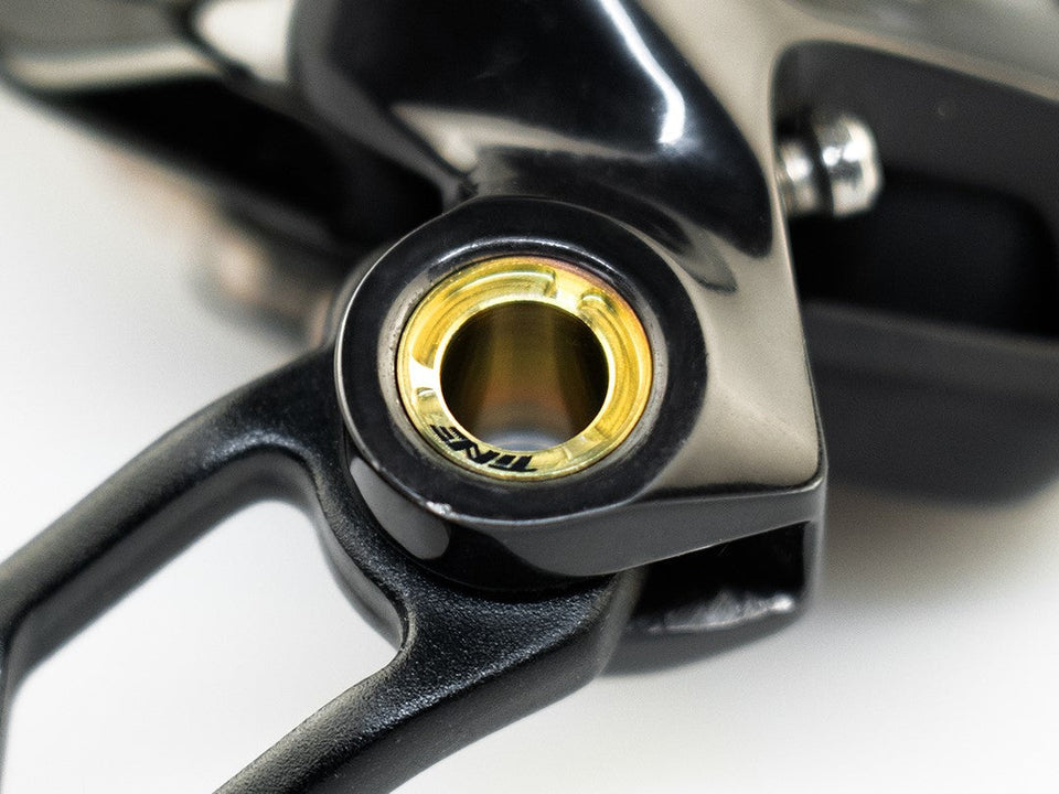 Rear derailleur pivot bolt with gold TiNE insert, black housing detail