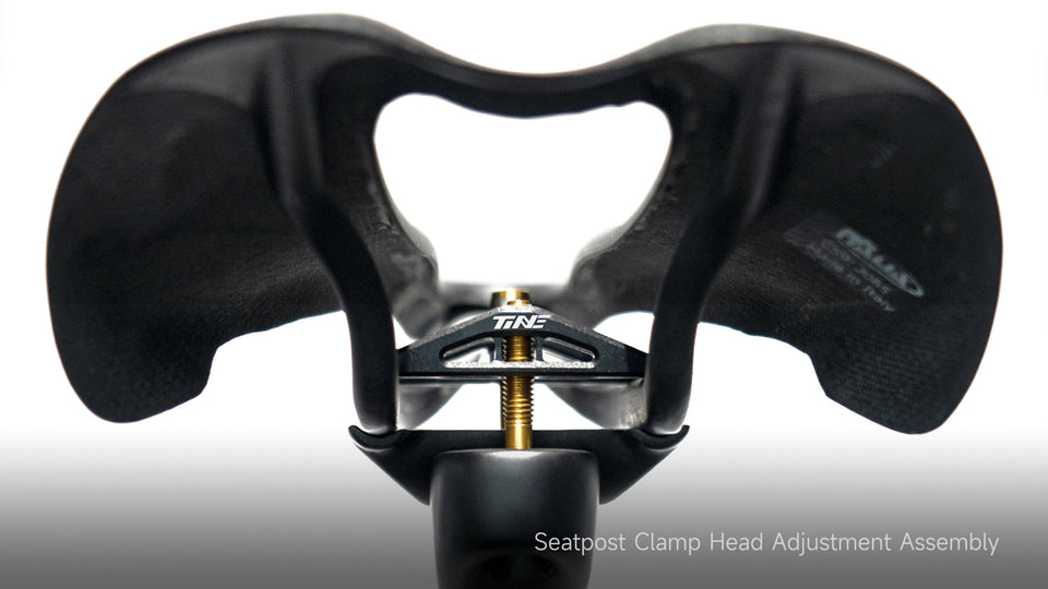 TiNE branded seatpost clamp head assembly with gold adjustment bolt
