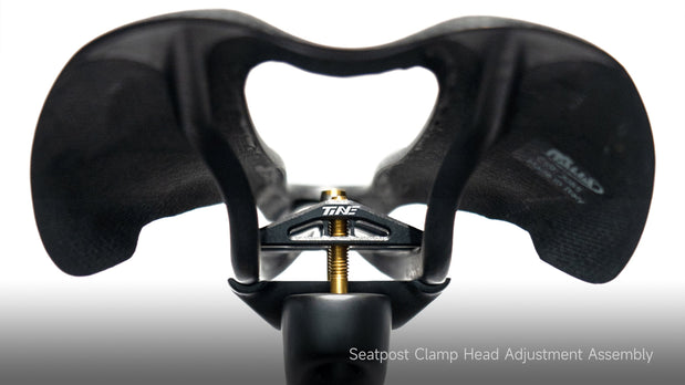 TiNE branded seatpost clamp head assembly with gold adjustment bolt