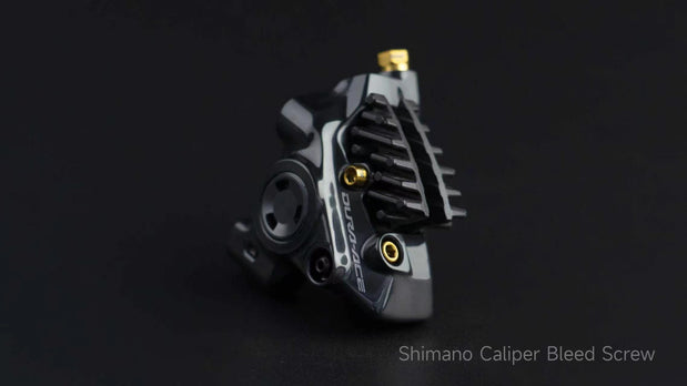 Shimano flat-mount caliper bleed port screws with gold titanium accents