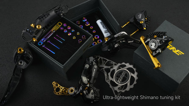TiNE titanium bolt kit for Shimano 105 with rainbow anodized bolts, gold derailleur hardware, and chainring on black display case.