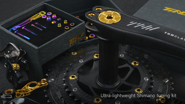 TiNE titanium bolt kit with gold hardware on carbon bike parts
