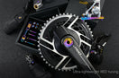 TiNE titanium bolt kit for SRAM RED AXS crankset with rainbow anodized bolts displayed alongside groupset components