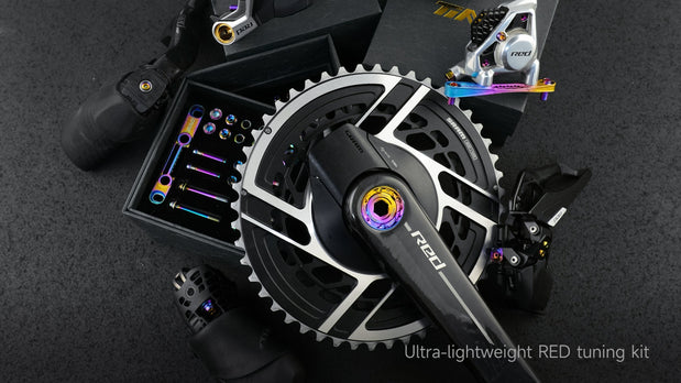 TiNE titanium bolt kit for SRAM RED AXS crankset with rainbow anodized bolts displayed alongside groupset components