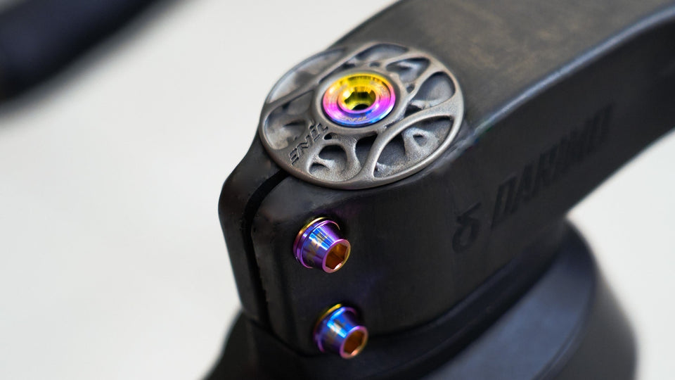 TiNE TECH titanium derailleur bolts, rainbow finish, on black component