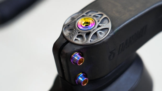 TiNE TECH titanium derailleur bolts, rainbow finish, on black component