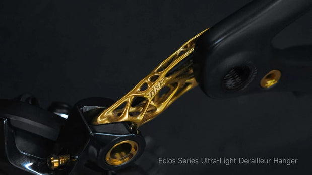 TiNE Tech Eclos ultra-light titanium derailleur hanger with gold lattice design