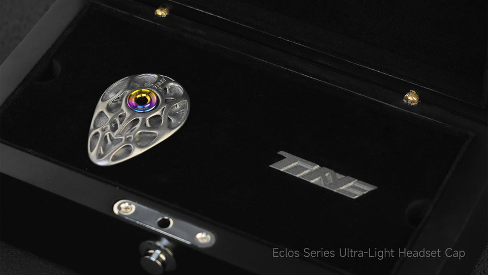 TiNE TECH Eclos Series ultra-light titanium headset top cap featuring bionic rib structure and iridescent bearing preload center, displayed in premium black case.