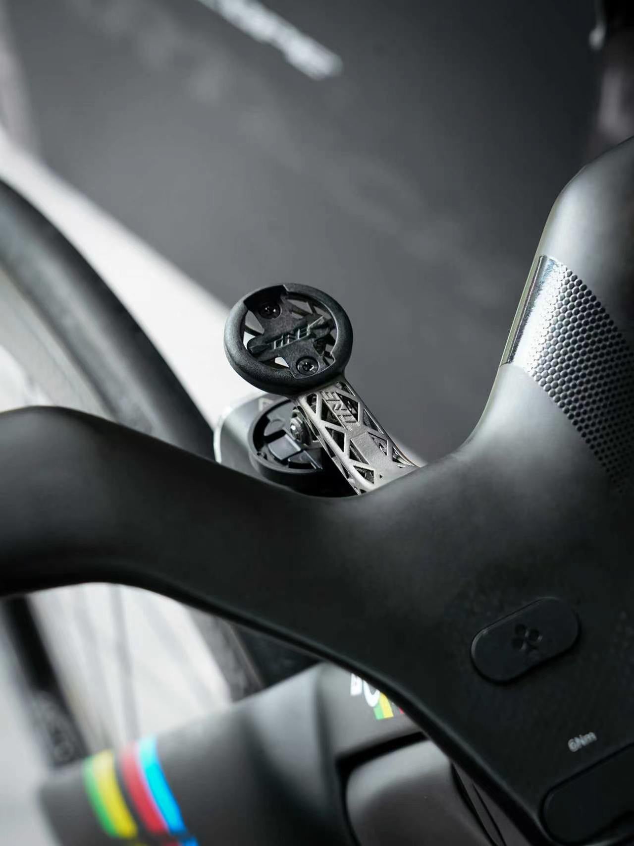 TiNE ultralight titanium road bike conversion kit mounted on sleek black handlebar with geometric design