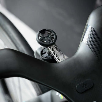 TiNE ultralight titanium road bike conversion kit mounted on sleek black handlebar with geometric design