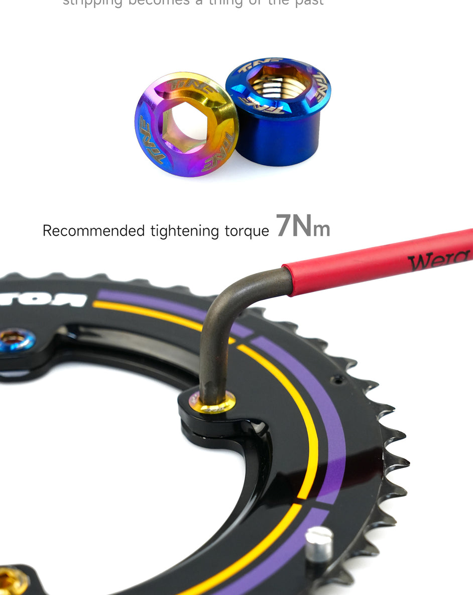 Two anodized titanium crank bolts in blue and gold colors displayed above a black bicycle chainring with purple and yellow accents, with a hex wrench tightening one bolt.