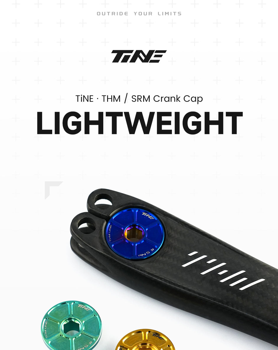 Close-up of a lightweight carbon crank arm with a blue titanium crank cap installed, alongside green and gold titanium crank caps on a white background, showcasing cycling components.