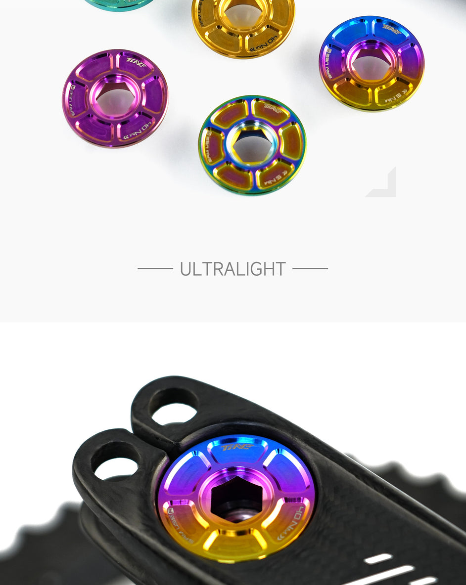 Five multicolored, anodized titanium crank cap screws displayed above a black bicycle crank arm featuring one installed cap in blue, purple, and gold gradient finish on a white background.