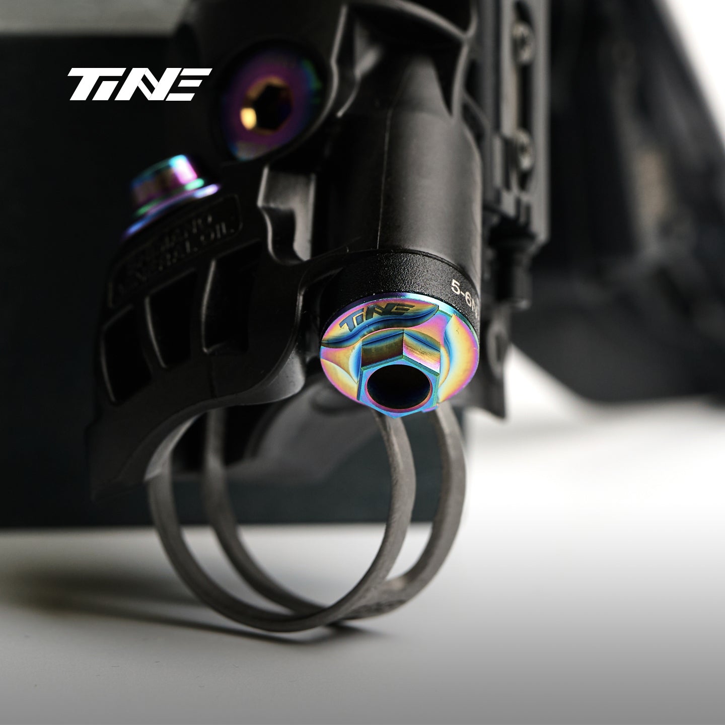 TiNE colorful titanium screw attached to Shimano hydraulic component