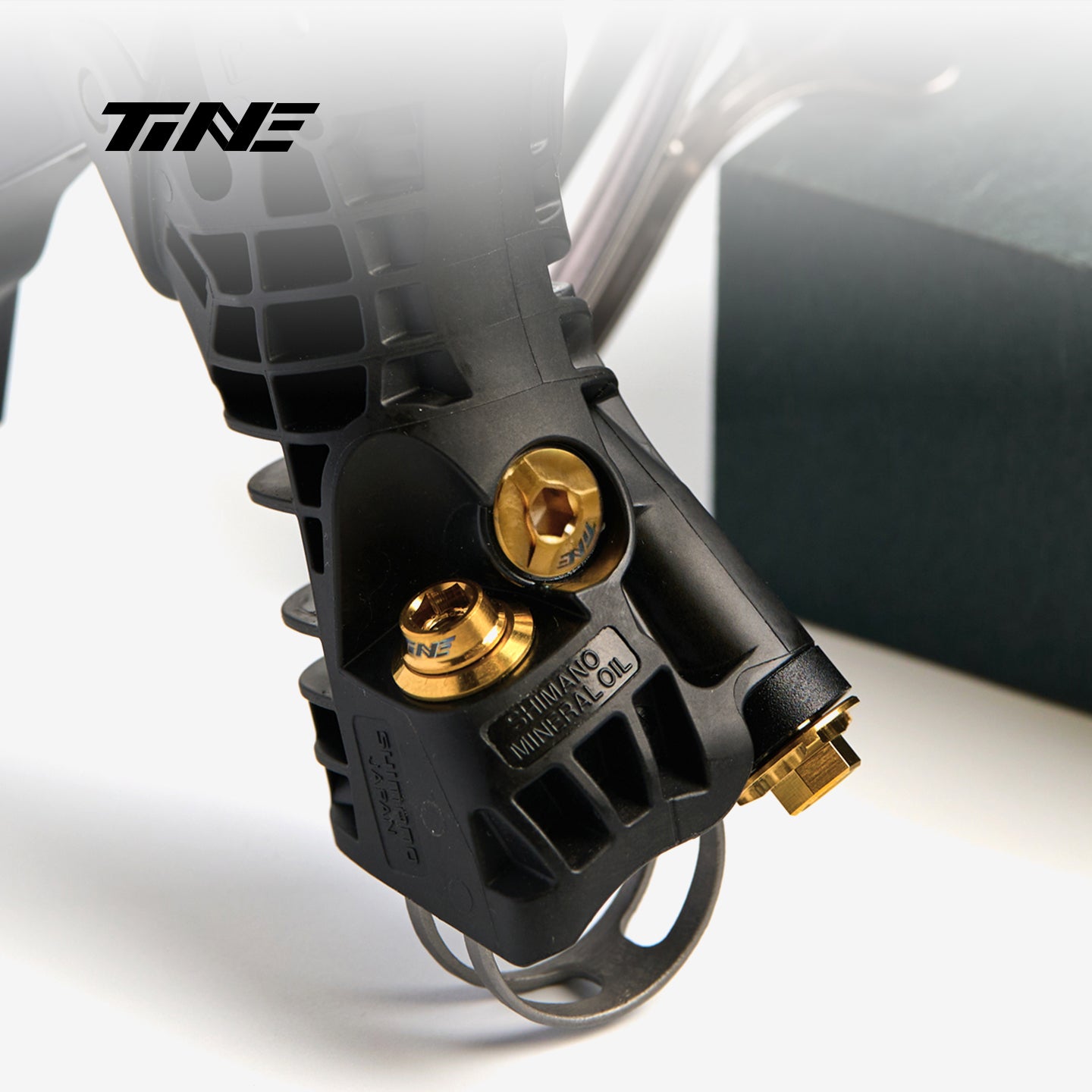 TiNE TECH Shimano lever bleed port screw with gold hardware and mineral oil label